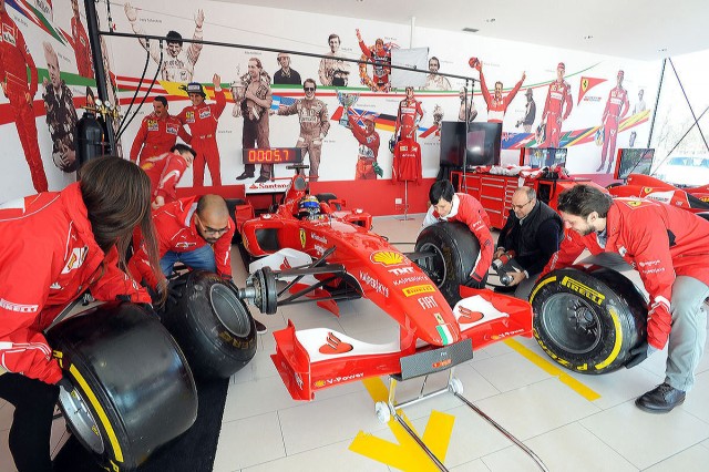 Bloggers getting up close to a Ferrari racecar.