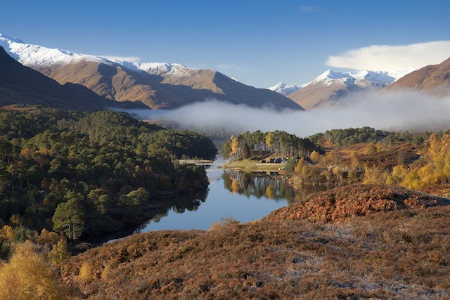 Looking west along Loch Affric to snow topped mountains in the Scottish Highlands (image by Visit Britain).